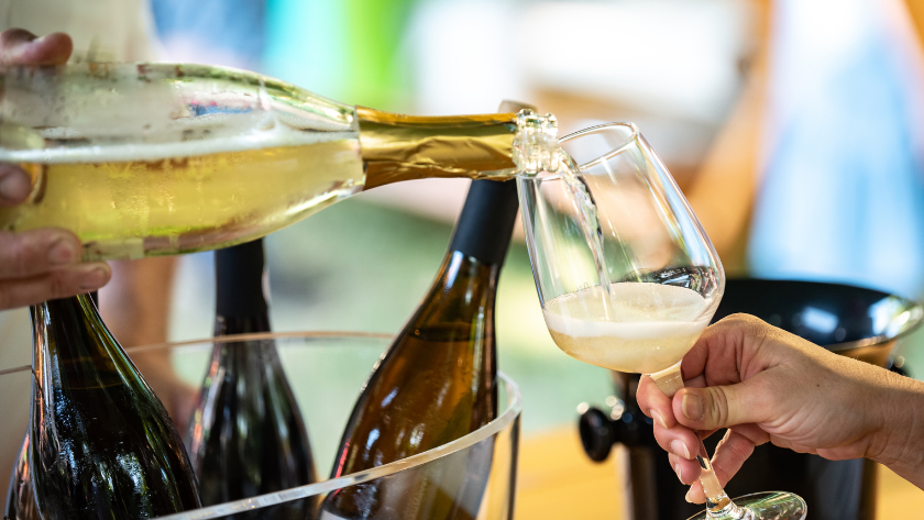 pouring a glass of sekt at wine festival germany 2025