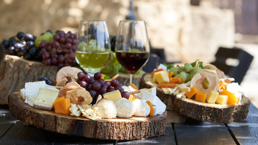 a white wine and red wine glass with snacks setup on a table at a Germany wine festival