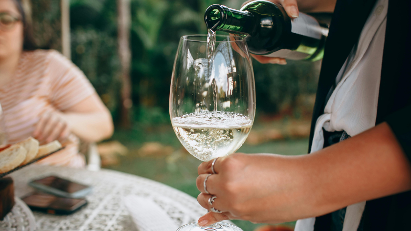 pouring a glass of white wine at a Germany wine festival