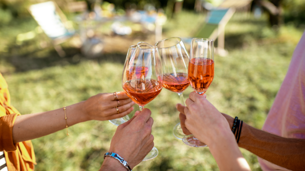 friends clinking Rosé glasses at a June wine events
